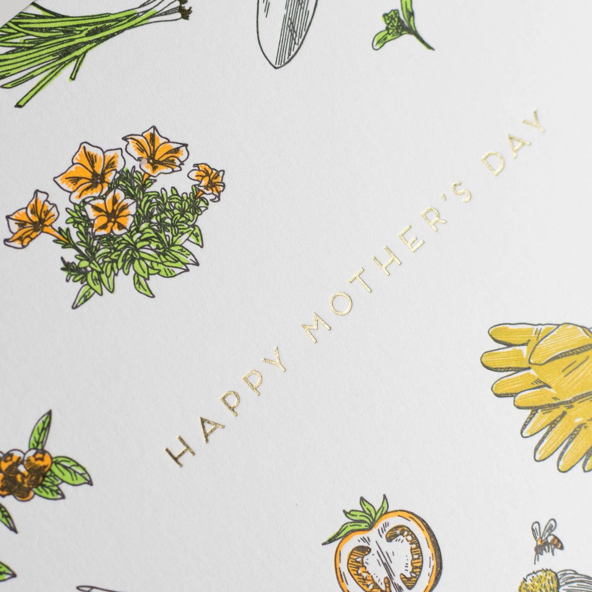 Close-up of Mother's Day gardening card with orange flowers and “Happy Mother's Day” text