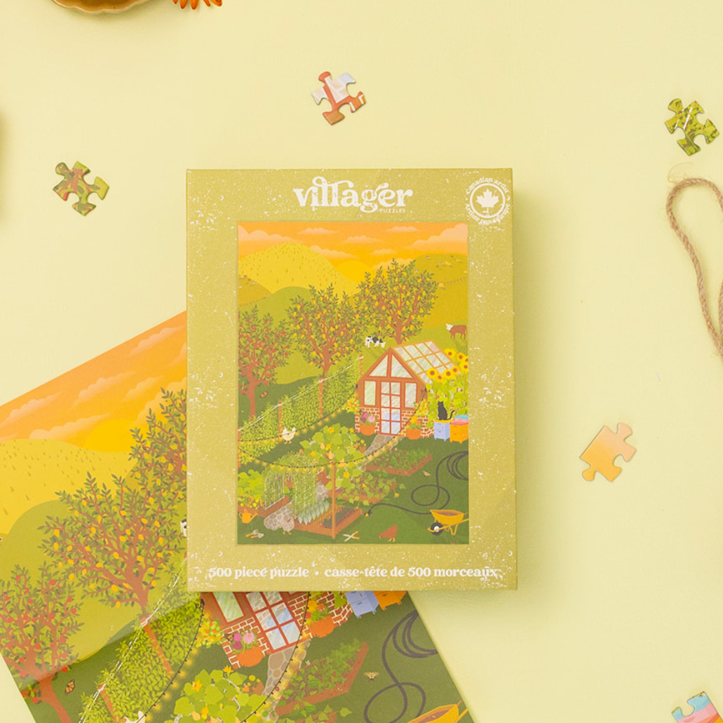500-piece jigsaw puzzle box with hobby farm artwork and scattered puzzle pieces