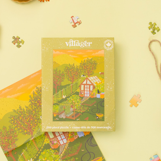 500-piece jigsaw puzzle box with hobby farm artwork and scattered puzzle pieces