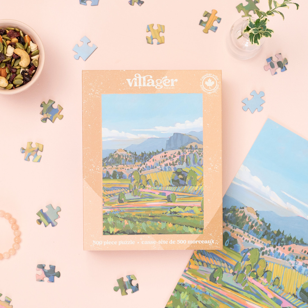 500-piece jigsaw puzzle box with scenic countryside artwork and scattered jigsaw pieces