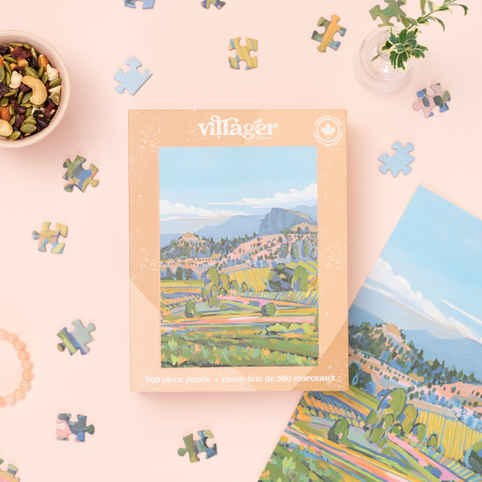 500-piece jigsaw puzzle box with scenic countryside artwork and scattered jigsaw pieces