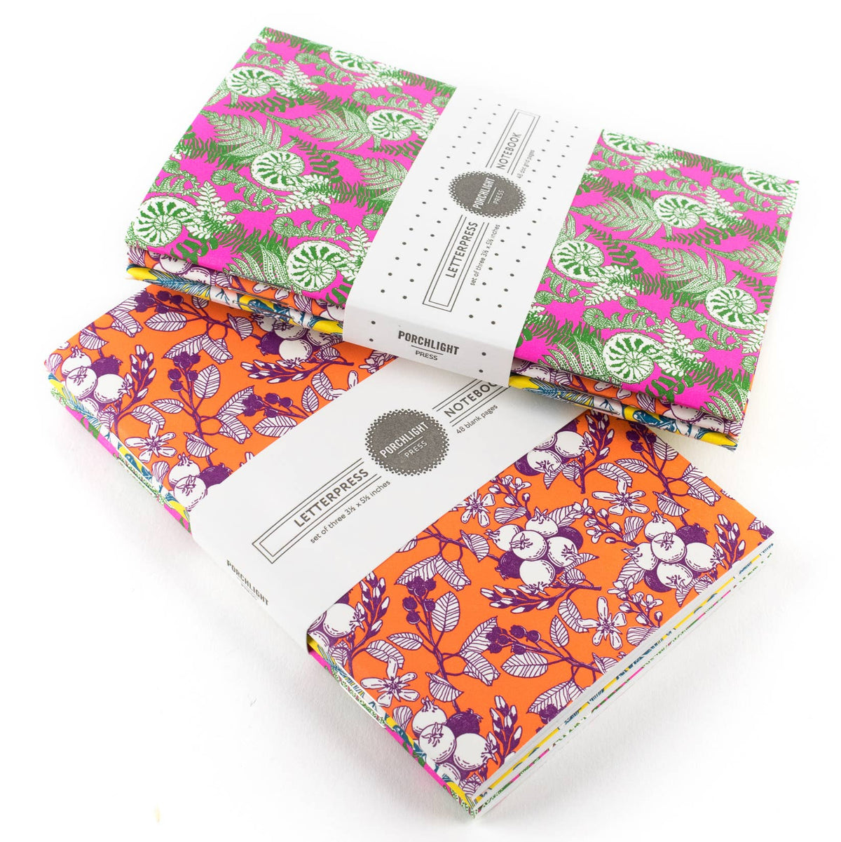 Set of 3 pocket notebooks with illustrated covers and centered brand label
