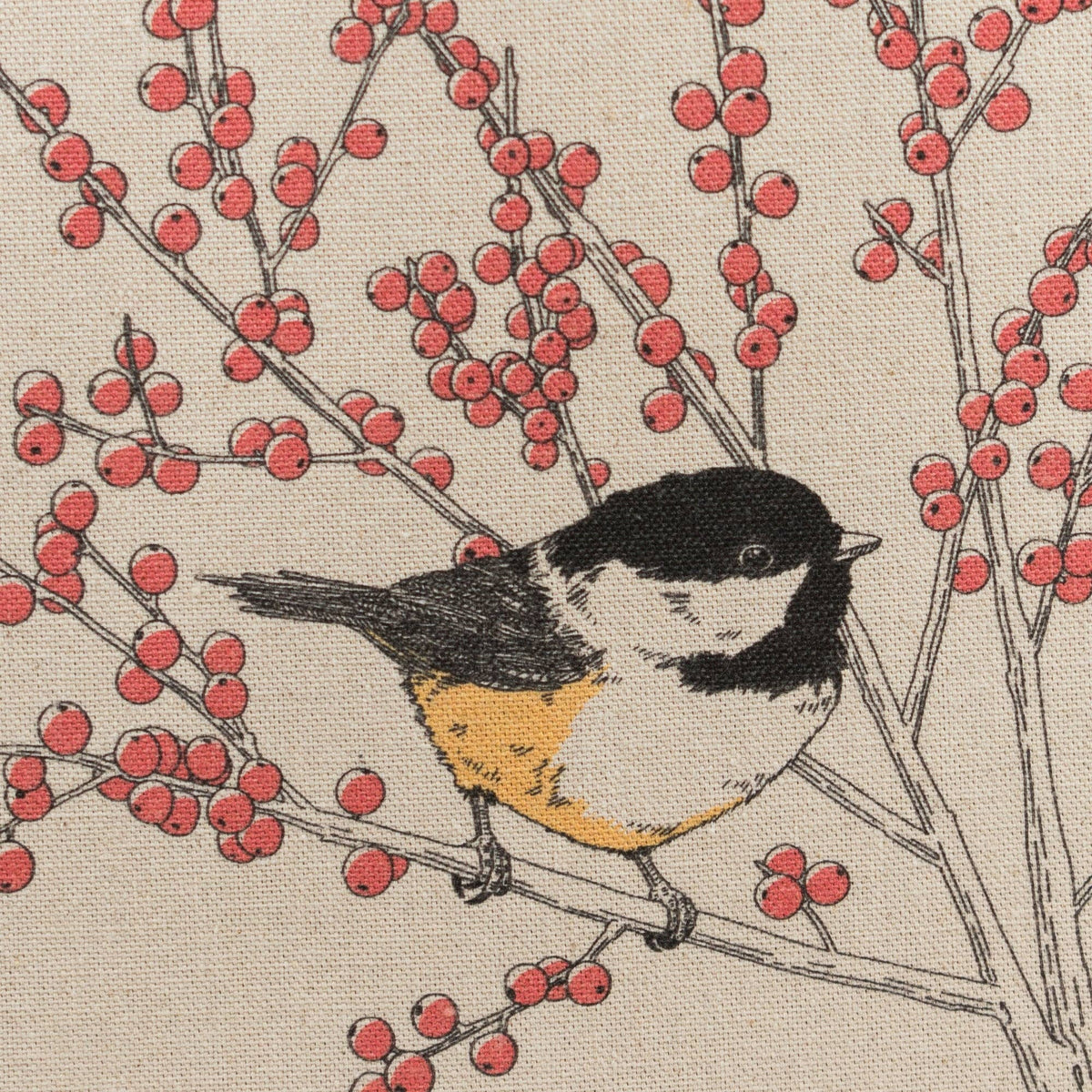 Cream canvas tote bag panel close-up with chickadee illustration and red berry branches