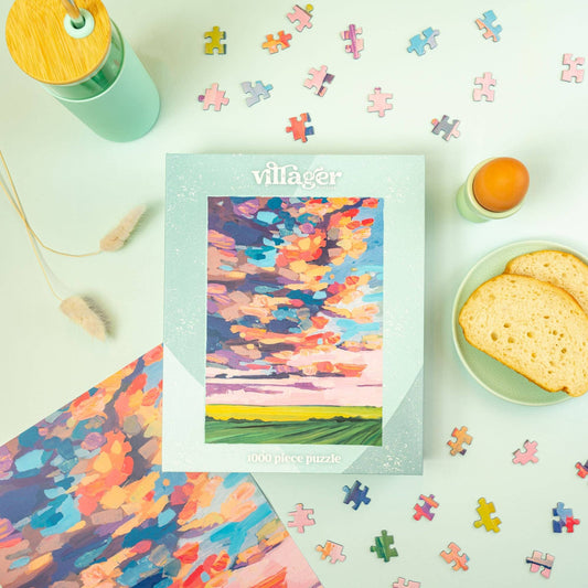 1000-piece puzzle with colorful prairie sky landscape art, shown with loose jigsaw pieces